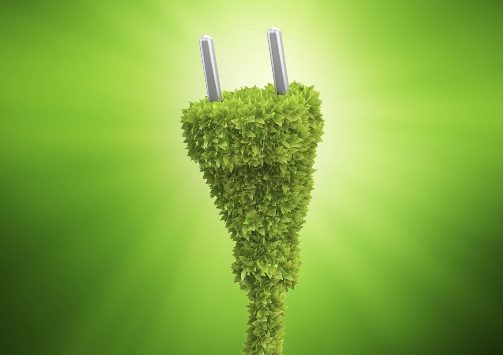 En växtbeklädd elkontakt mot en grön lysande bakgrund.