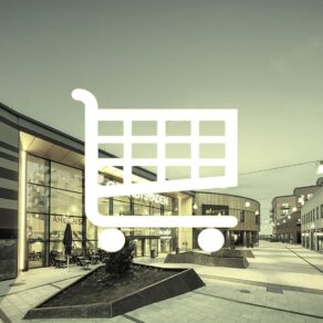 Vit kundvagnsikon framför en handelsplatsmiljö.