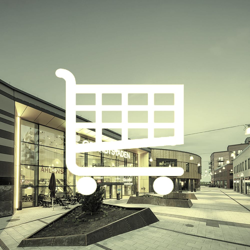 Vit kundvagnsikon framför en handelsplatsmiljö.